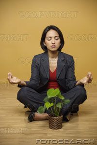 businesswoman-meditating-with-a-plant---hs050661ind.jpg