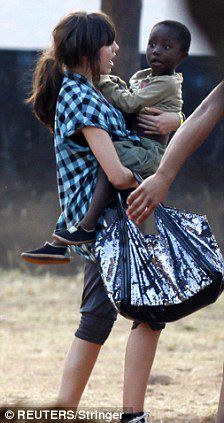 Lourdes holds one of the many children who live at the Malawian orphanage