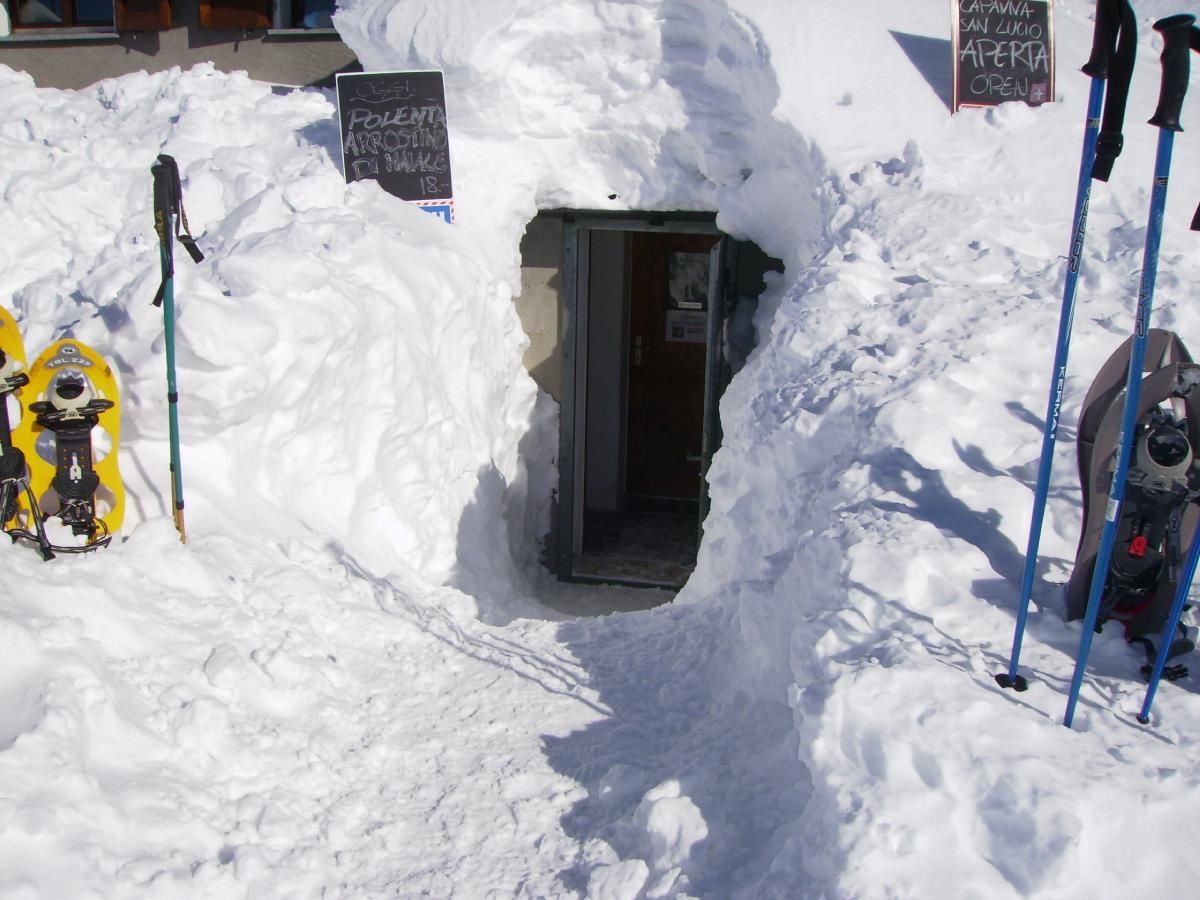 L'entrata della capanna svizzera del passo del San Lucio sommersa dalla neve