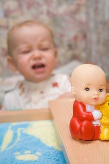 toy and crying baby on the background