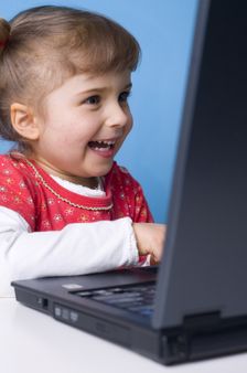 Little girl working on computer
