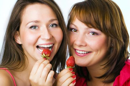 happy couple woman eat strawberry on white