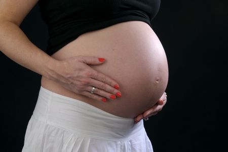 pregnant woman holding stomach