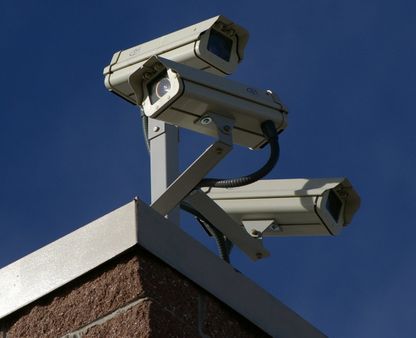 Three surveillance cameras on the corner of a building | Source | Date