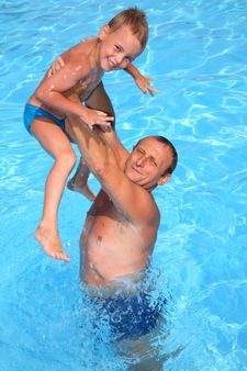 granddad with grandson in the pool