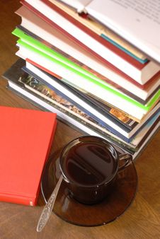 Cup of coffee and a pile of books