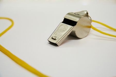 Metal whistle with the yellow cord