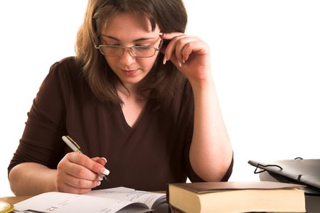 Young woman in glasse writing something in copybook