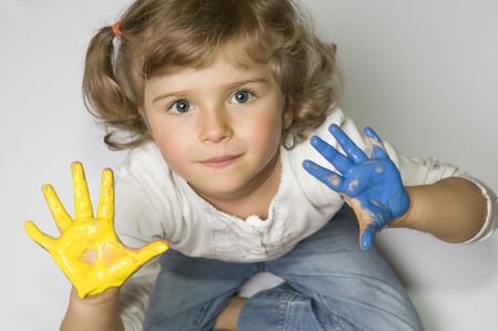 Little girl with colored hands