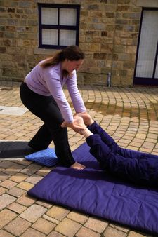 Loosening the pelvis as part of a Thai body massage.