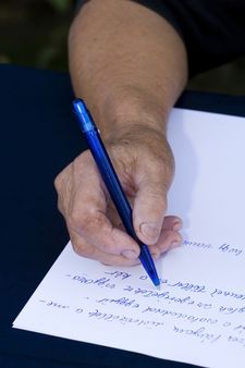 Woman's hand holding a pen writing