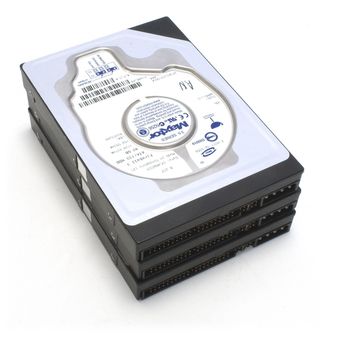 An image containing a stack of three Maxtor hard disks on a white back