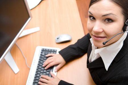 happy businesswoman at desk with headphone