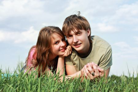 Beautiful couple lying on the grass