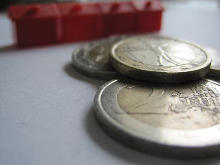 Euro coins and houses