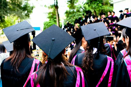 Beautiful Asian university graduates celebrate their success.