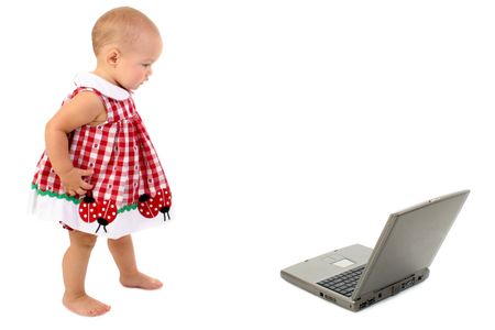 beautiful toddler girl walking towards laptop comp