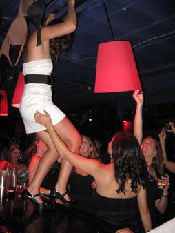 A woman dances on the bar at a Hen party in San Francisco, USA. | Sou