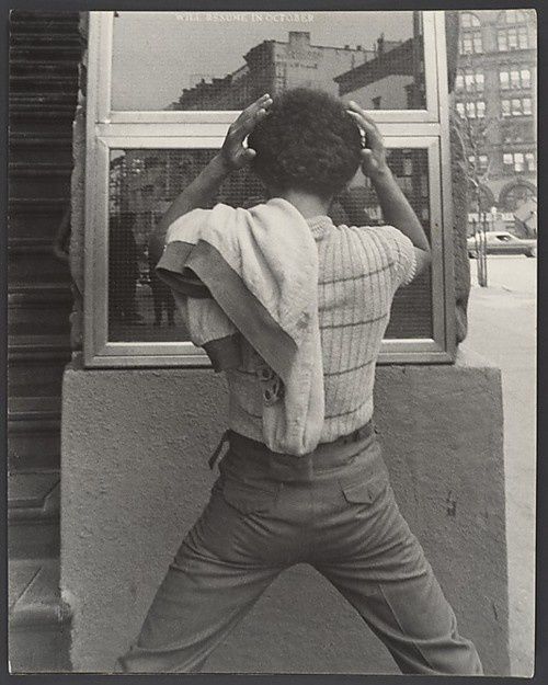 Young-Man-FixingHair-in-Window-New-York-City-1970sLeon-Lev.jpeg